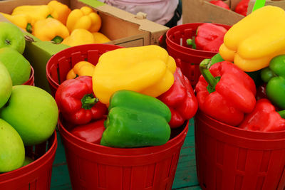 Bell peppers in containers for sale at market