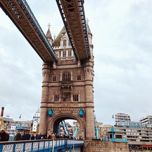 Low angle view of clock tower against cloudy sky