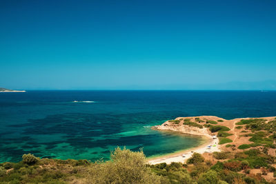 High angle view of bay against blue sky