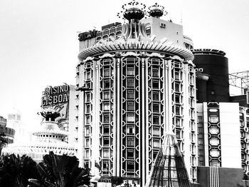 Low angle view of ferris wheel against buildings in city