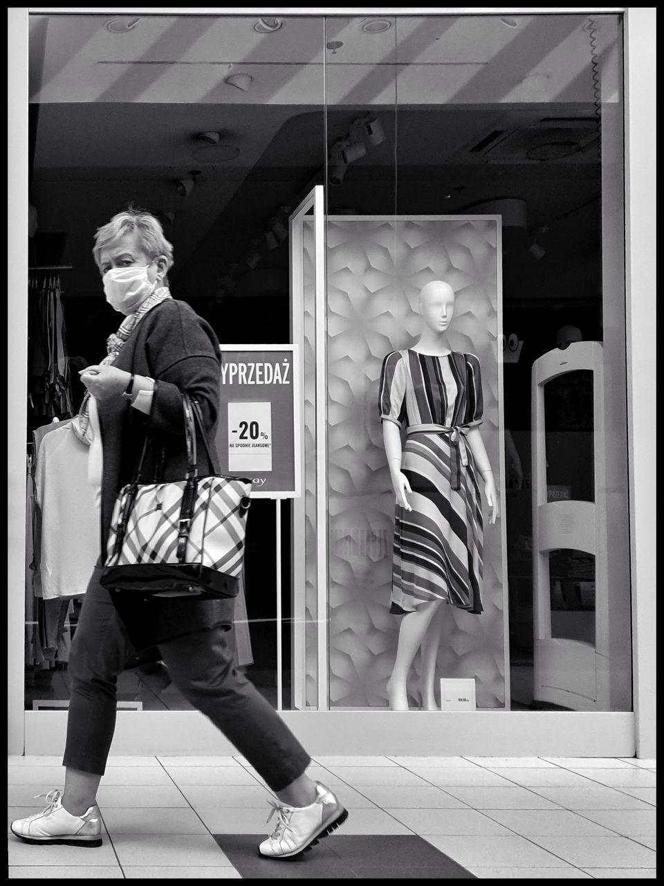 REAR VIEW OF MAN STANDING WITH TEXT IN STORE