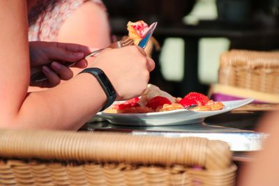 Close-up of woman preparing food on table