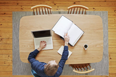 Man using laptop, directly above