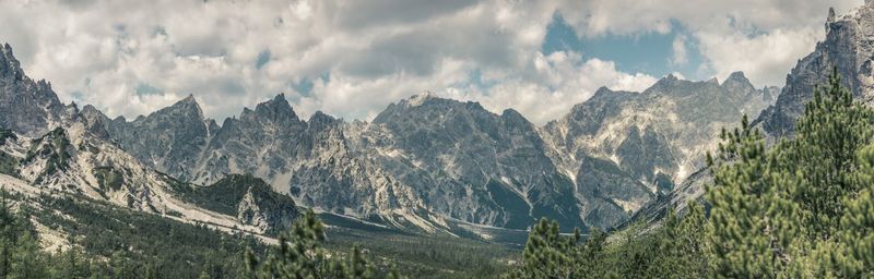 Scenic view of mountains against cloudy sky