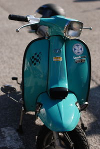 Close-up of motor scooter on road
