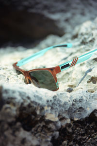 Close-up of sunglasses on rock