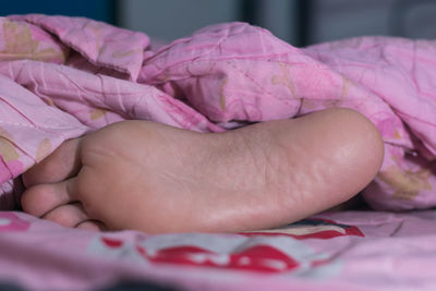 Close-up of baby feet on bed