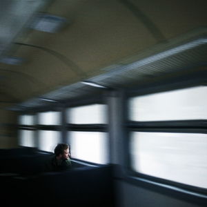 Side view of man in train at subway station