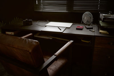 High angle view of chair at desk