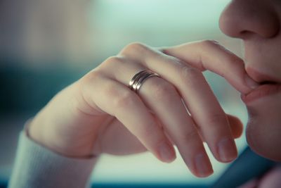 Cropped image of woman biting nails