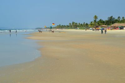 Scenic view of beach against blue sky