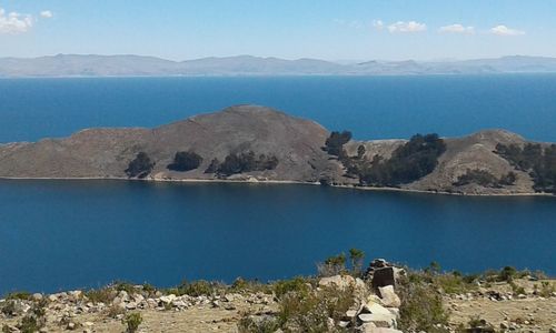 Panoramic view of sea and mountains against sky