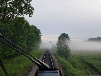 Railroad tracks seen through train windshield