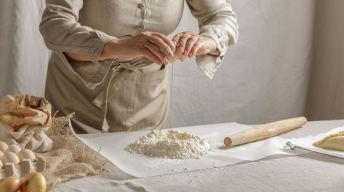 Midsection of woman preparing food on table