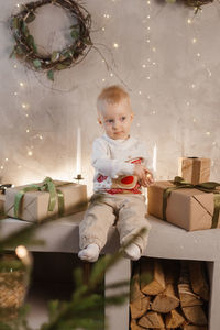 A little boy is playing on christmas eve in a beautiful house decorated for the new year holidays