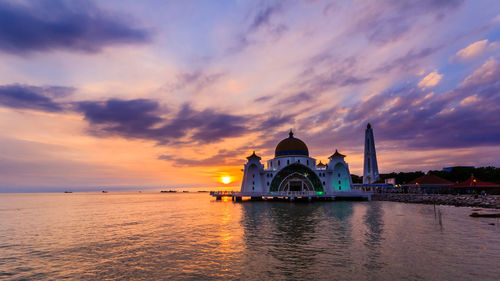 View of building against cloudy sky during sunset