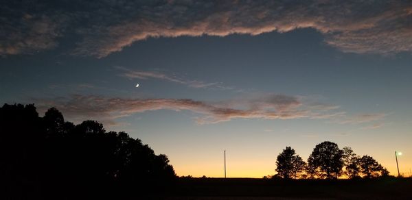 Low angle view of silhouette trees against sky during sunset