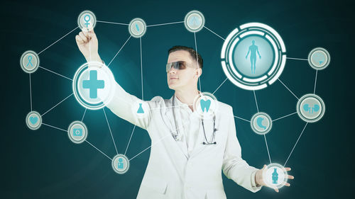 Digital composite image of doctor touching icons against colored background