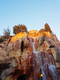 Low angle view of rock formation against clear sky