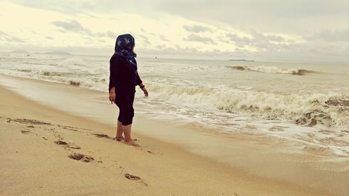 Full length of man walking on beach