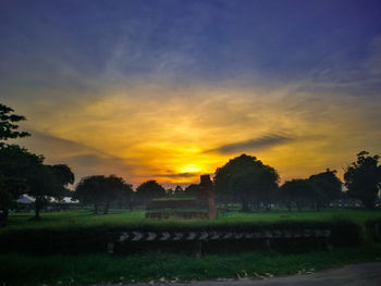 Scenic view of field against sky during sunset