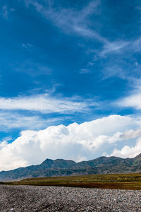 Scenic view of mountains against cloudy sky