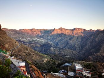 High angle view of buildings and mountains against sky