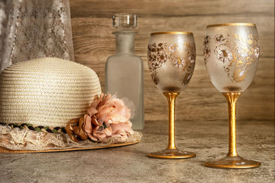 Still life of two empty glass of wine with wine bottle and white hat