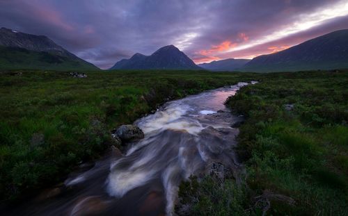 Scenic view of mountains against cloudy sky
