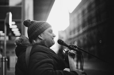 Full length portrait of young man playing guitar