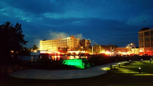 Illuminated city against sky at night