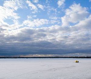 Scenic view of snow covered land against sky