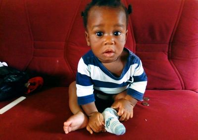 Portrait of cute baby girl sitting