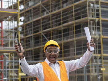 Portrait of man standing against buildings