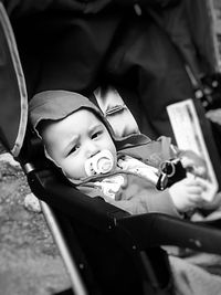 Portrait of baby with pacifier on carriage