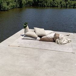 Lounge chairs by lake against trees