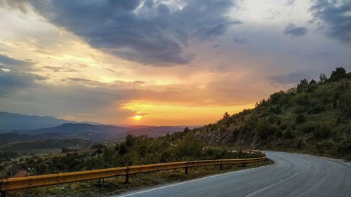 Scenic view of road against sky during sunset