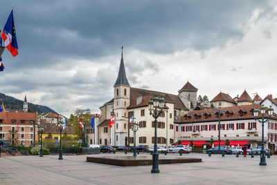 Street amidst buildings in town against sky