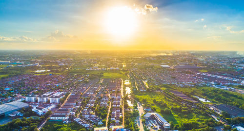 High angle view of city buildings against sky during sunset