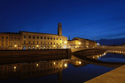 Reflection of buildings in water at night