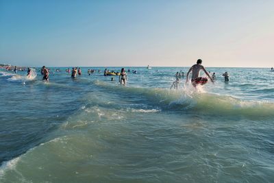 People on beach against sky