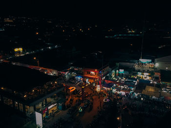 High angle view of illuminated buildings in city at night