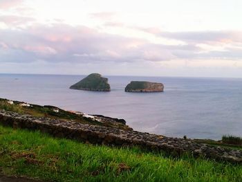 Scenic view of sea against cloudy sky