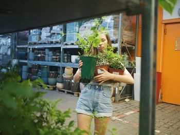 Woman holding potted plant