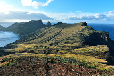 Scenic view of sea and mountains against sky