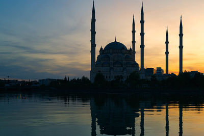 View of river at sunset with mosque