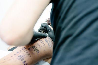 Midsection of person holding paper