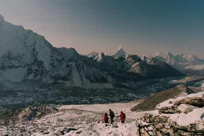 Scenic view of snowcapped mountains against sky during sunset