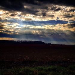 Scenic view of landscape against cloudy sky