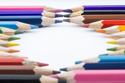 Close-up of colored pencils on white table